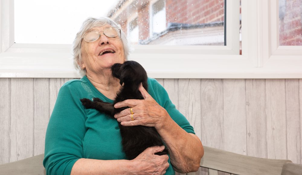 Resident with puppy at Cornwallis Court