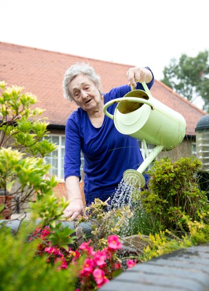 Resident watering plants at The Tithebarn