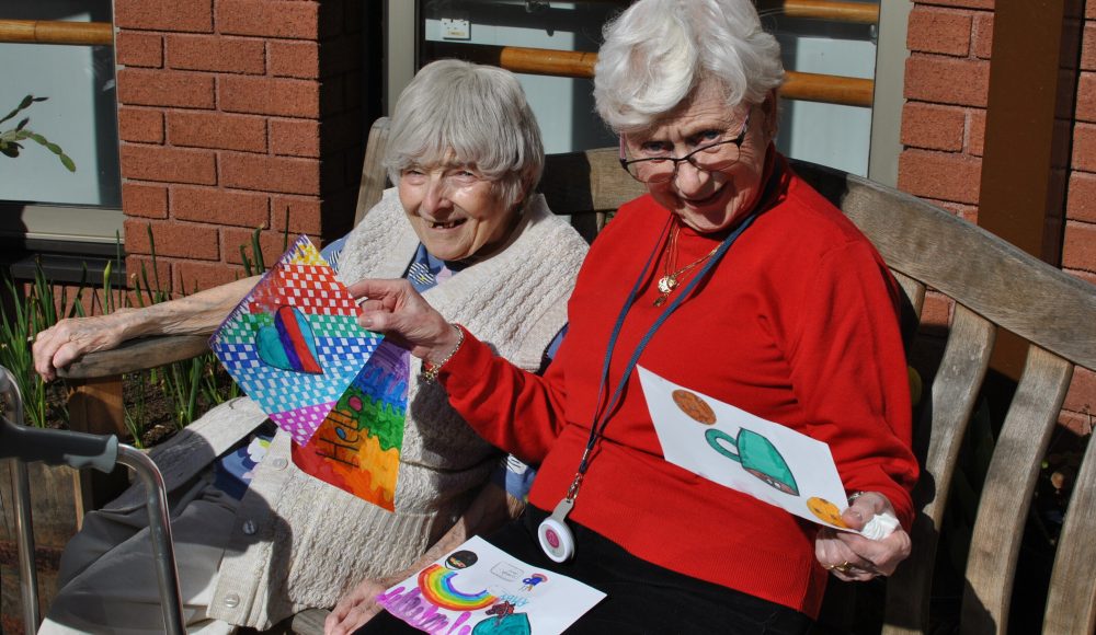 Residents read messages from the local community at Cadogan Court