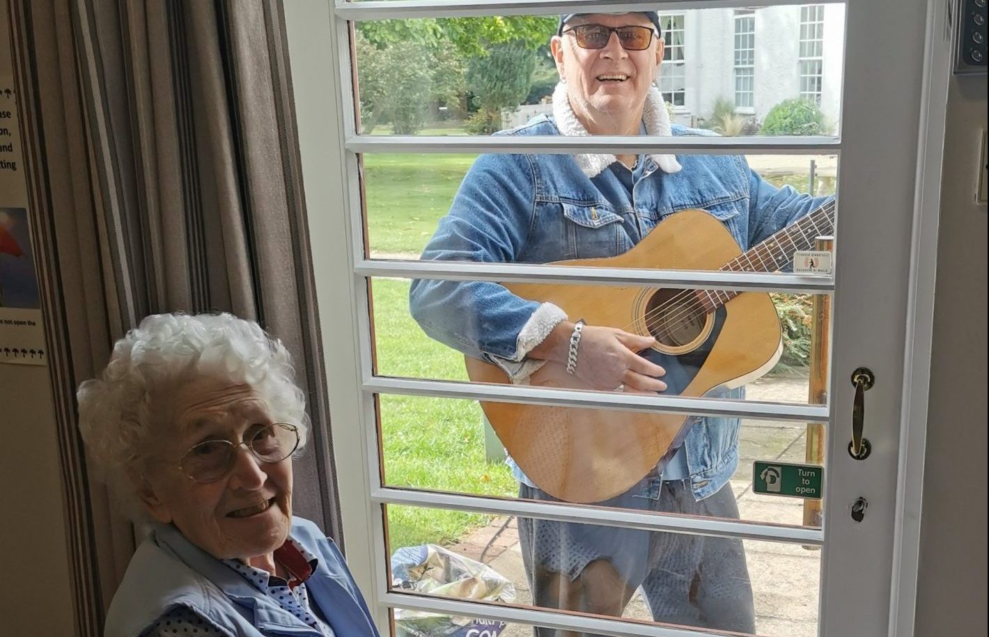 Local musician Pete Brill performs for delighted resident Betty