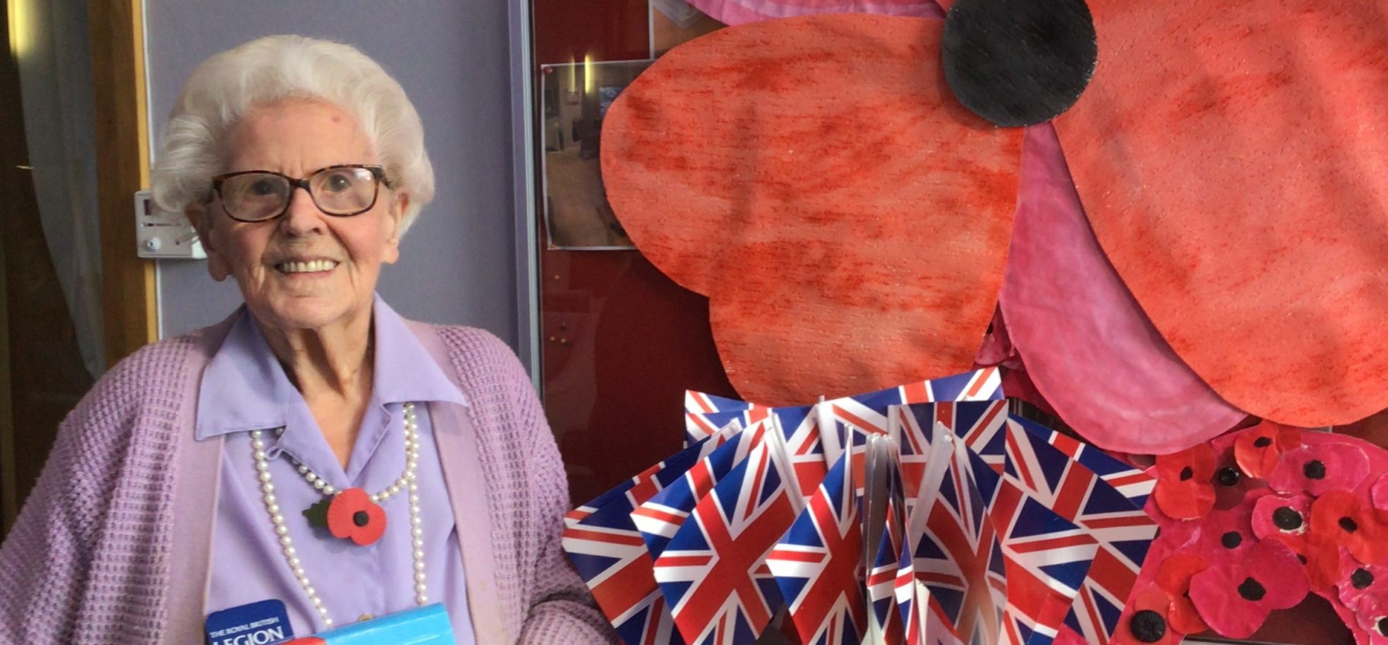 Connaught Court resident, Joan Brown, aged 99, in front of the Home’s Remembrance Day display with her poppies.