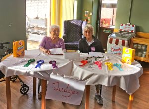 Residents Dylis Waddington (left) and Mollie Gould (right), who became the Dog Show judges, keep count of the scores for every category.
